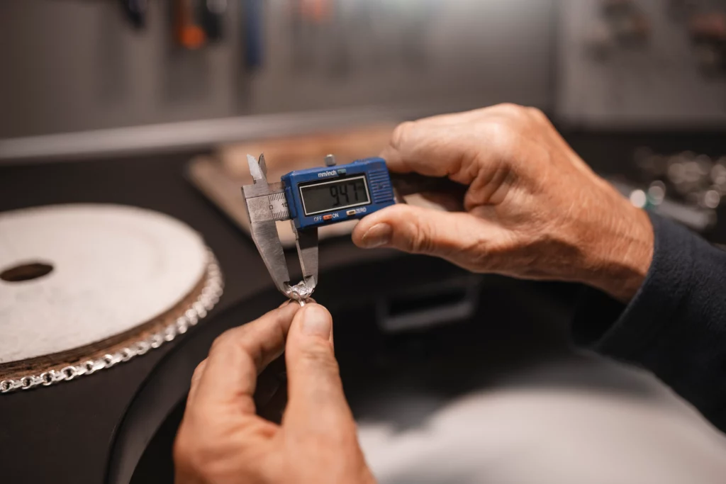 male-jeweler-working-shop-with-measuring-device